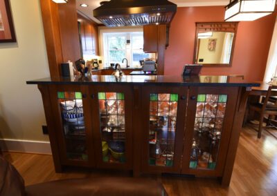 A tidy kitchen interior with wooden cabinetry, granite countertops, and modern appliances.